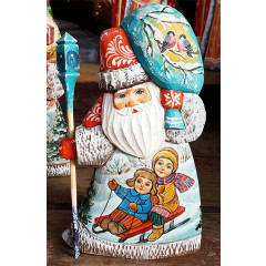 New Year and Christmas carved wooden toy Santa Claus is small, miniatures children on sleigh and snowman